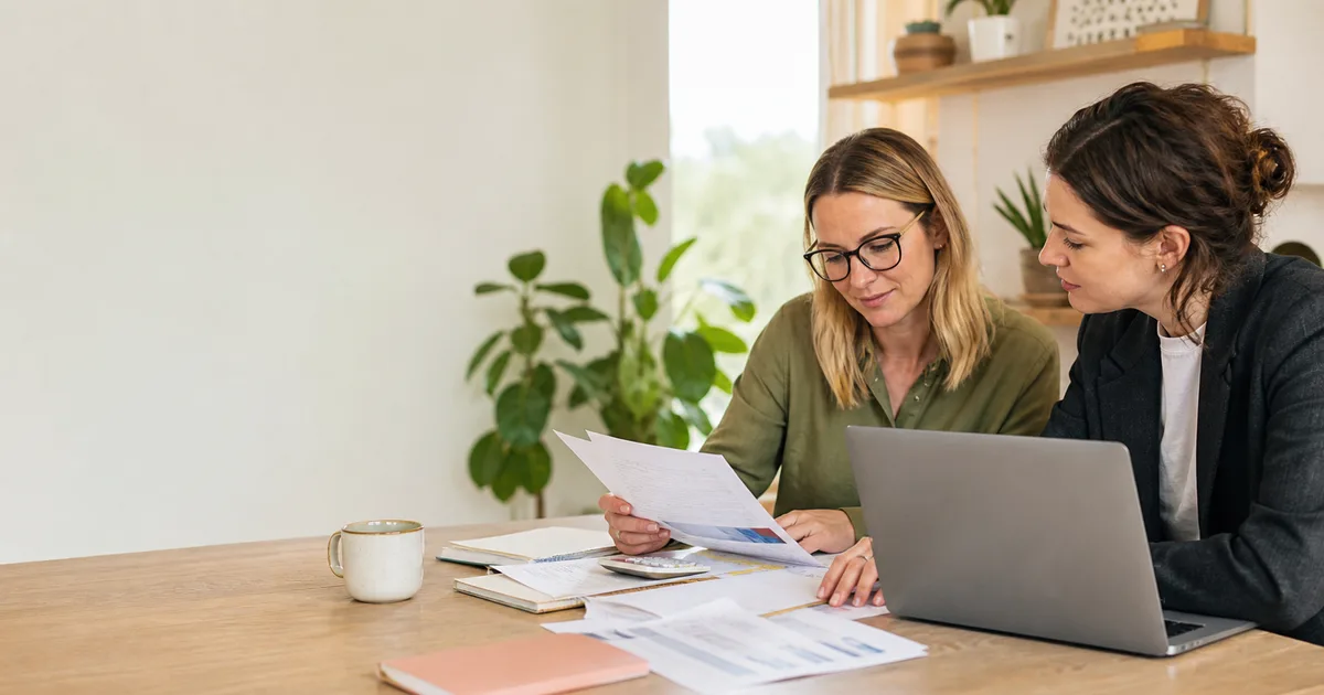 Victorian small-business owner reviewing bookkeeping records with a bookkeeper